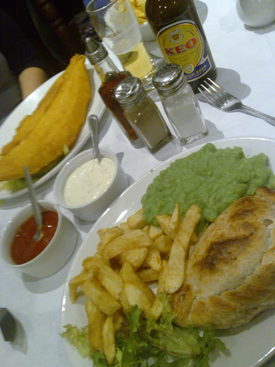 there is a plate with fish, chips and salad