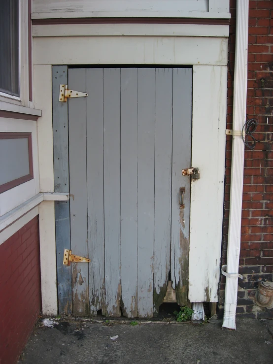 an old door sits outside a dilapidated building