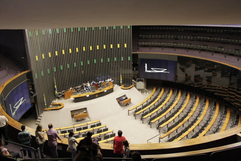 an overview of a round room that has rows of seats and a podium on top