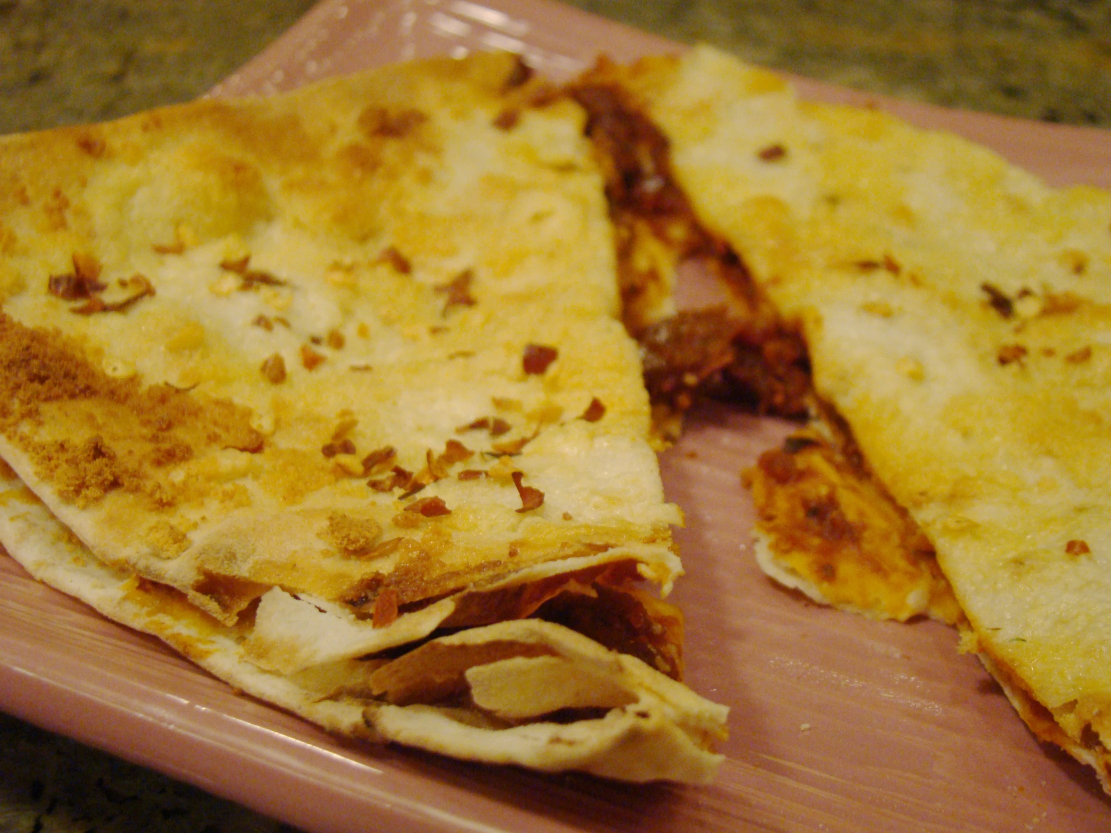 two large flatbreads on a plate on the counter