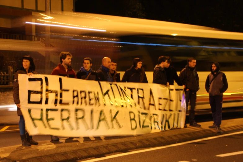 the people on the street are holding a sign