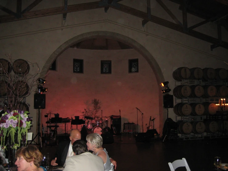 a wedding party is sitting in a large room