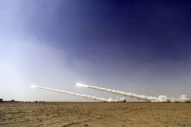 a couple of large jets flying over a desert