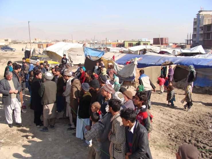 many people crowd around tents outside the desert