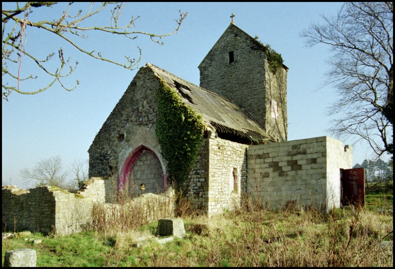 an old church with plants growing on it