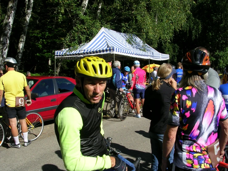 a man wearing a neon yellow helmet rides his bike