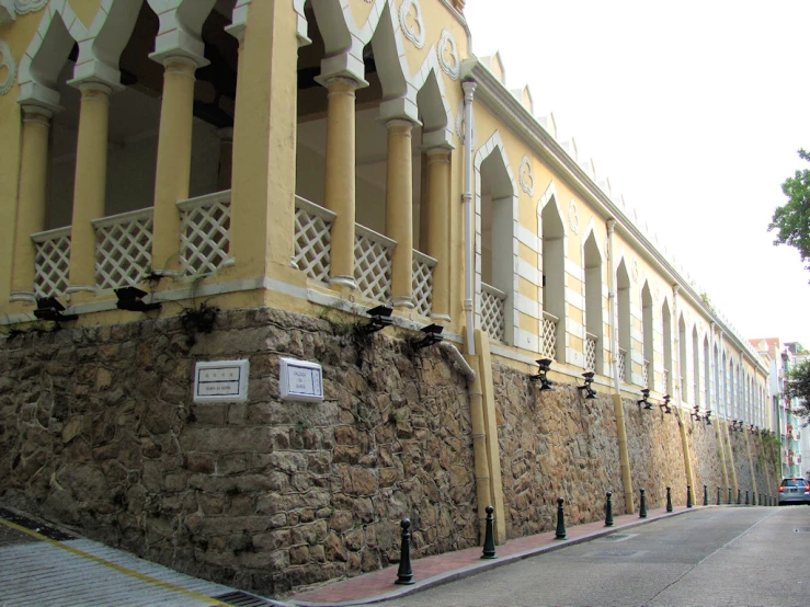 two buildings with windows sit along the side of a street