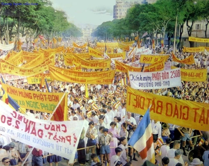 a crowd with flags and banners in the street