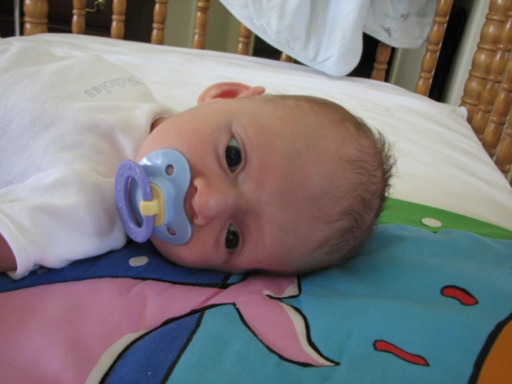 a baby with an electronic pacifier in his mouth