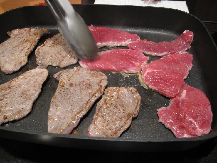 steak being prepared in a set with meat