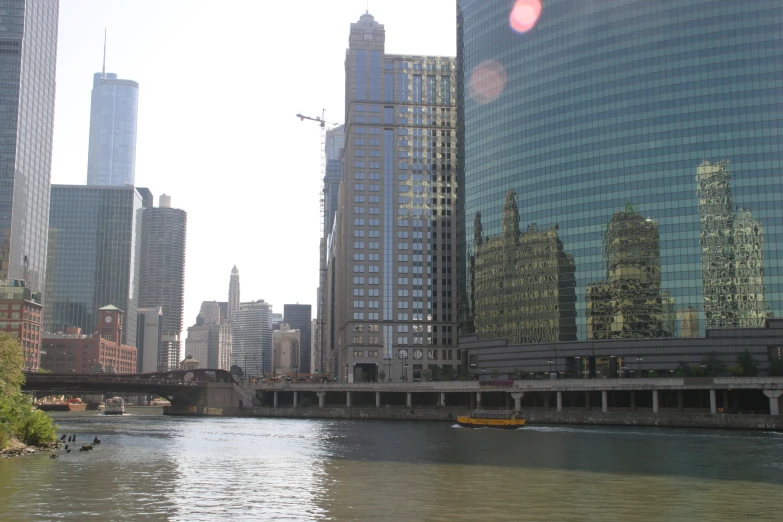 a body of water near several tall buildings