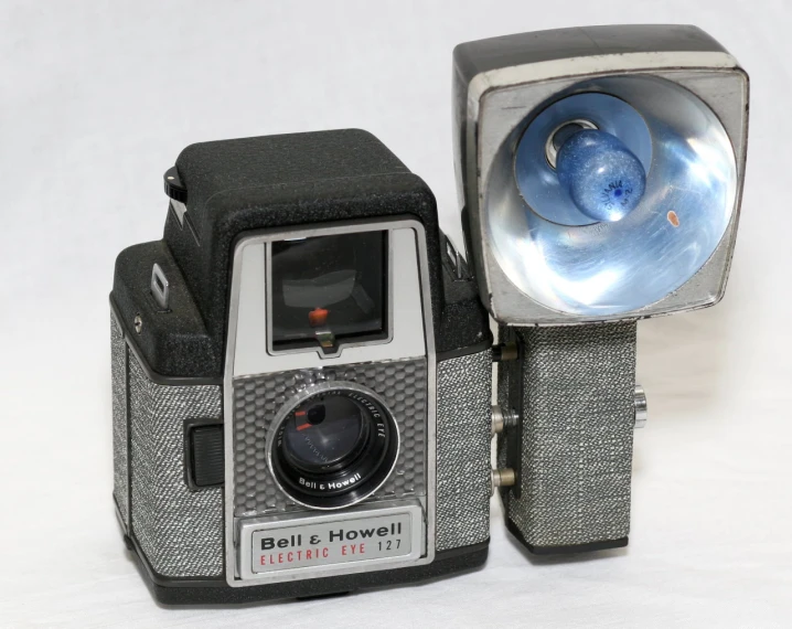 two old vintage cameras, one silver and one black