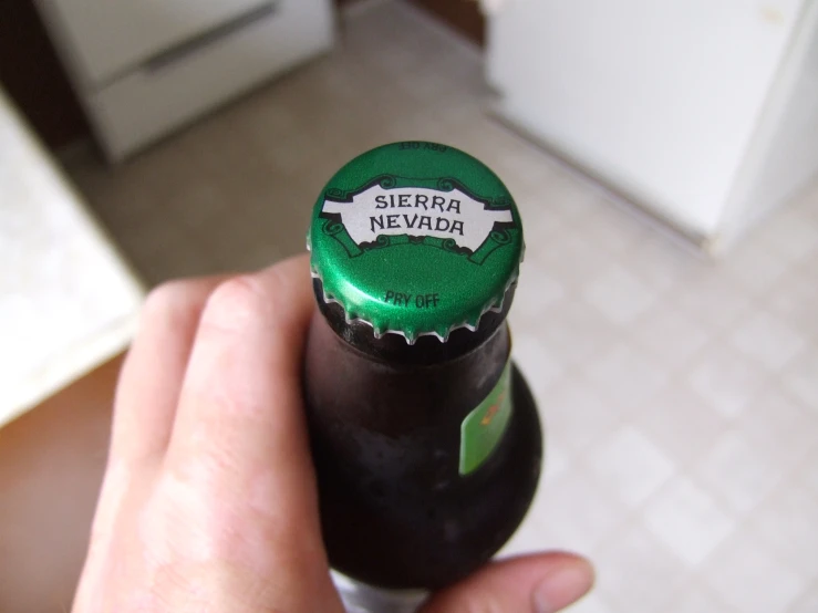 a hand is holding a bottle with the label sierra dewfor