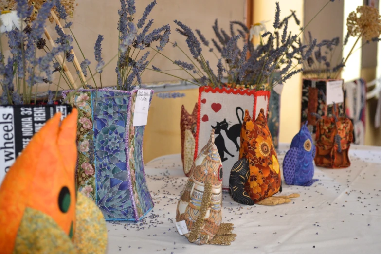 decorative vases sitting on a table with flowers in them