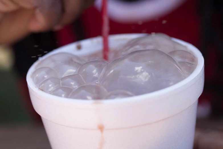 a person is filling a cup with water