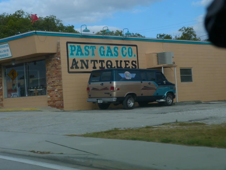 an antique motor shop with a van parked in front