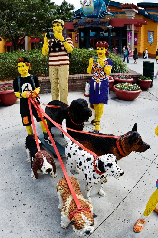 a few toy dogs are pulling along a rope