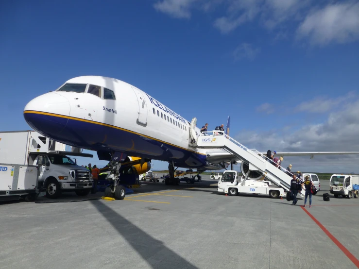 a jetliner on an airport tarmac with a stair ramp
