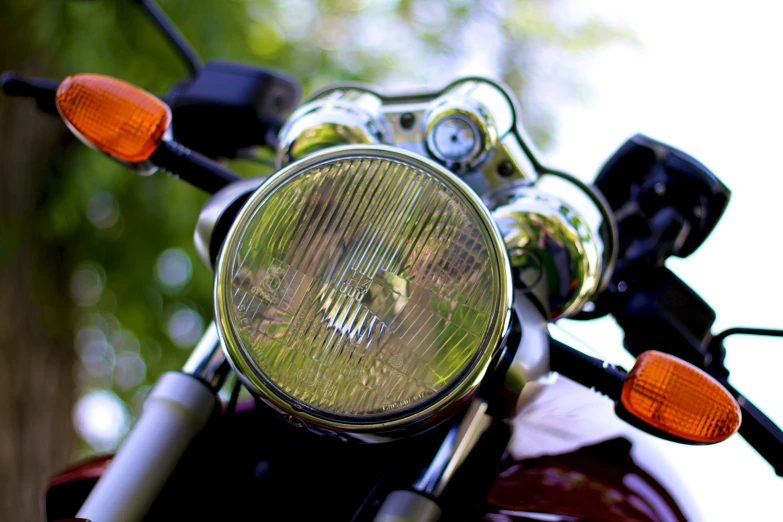 the headlight of a motorcycle is visible with the light on