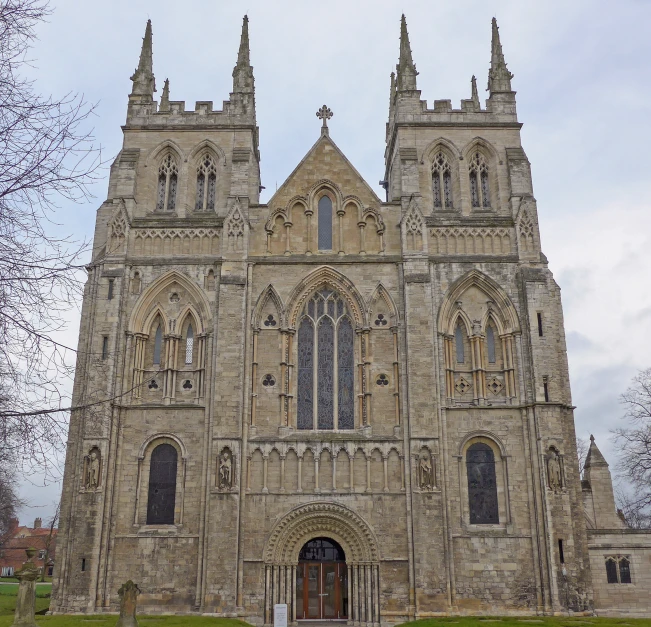 a large cathedral with multiple windows next to a park