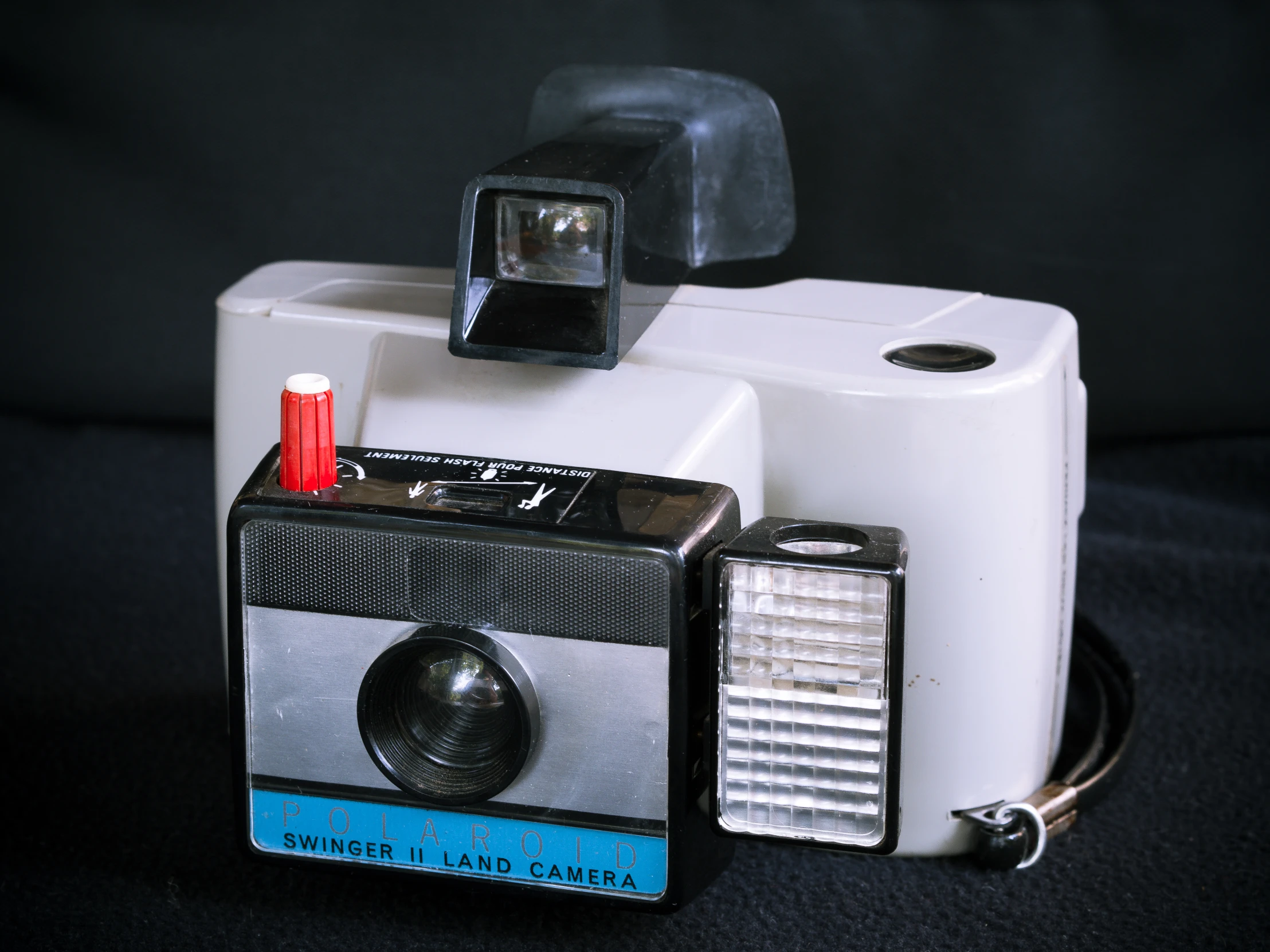 a very old fashioned camera with a red light on top