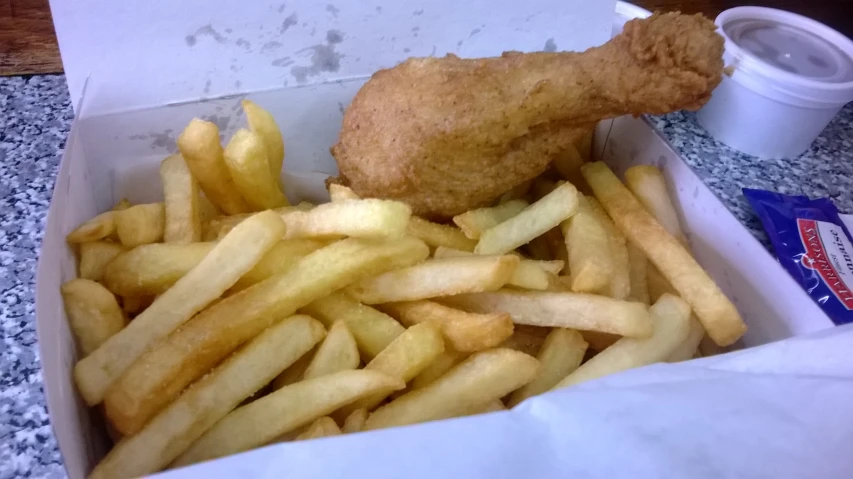 a box of fried food with fries in it