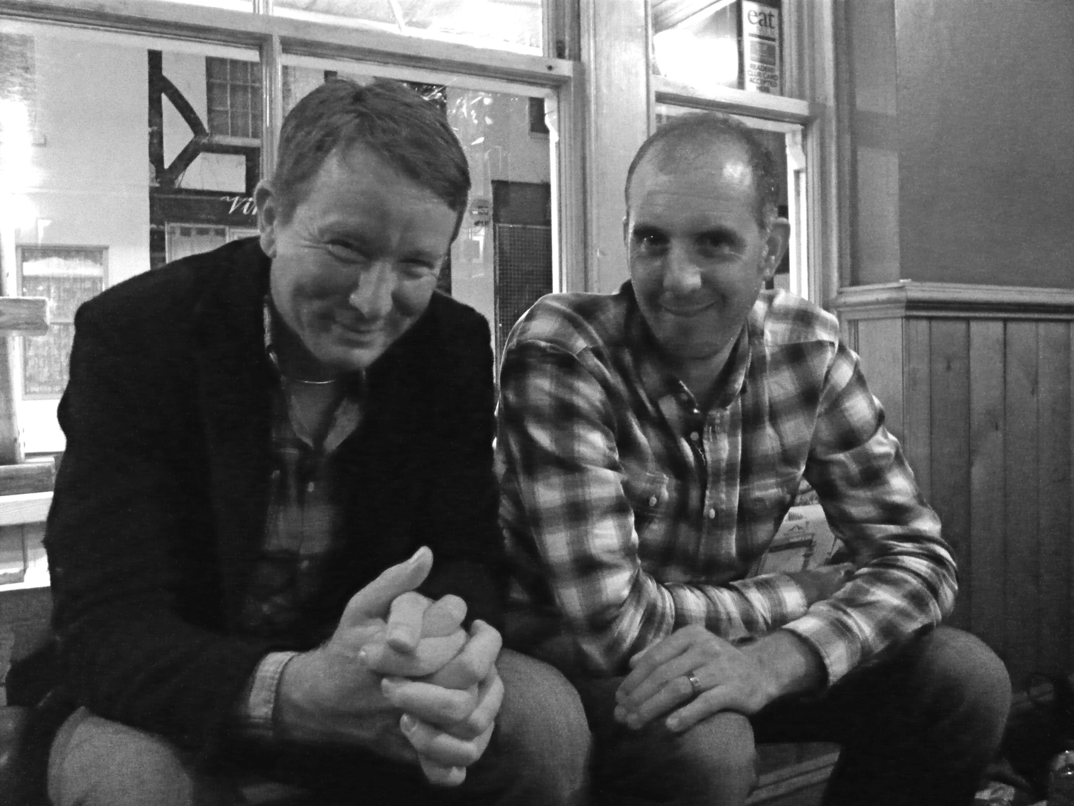 black and white pograph of two men sitting together