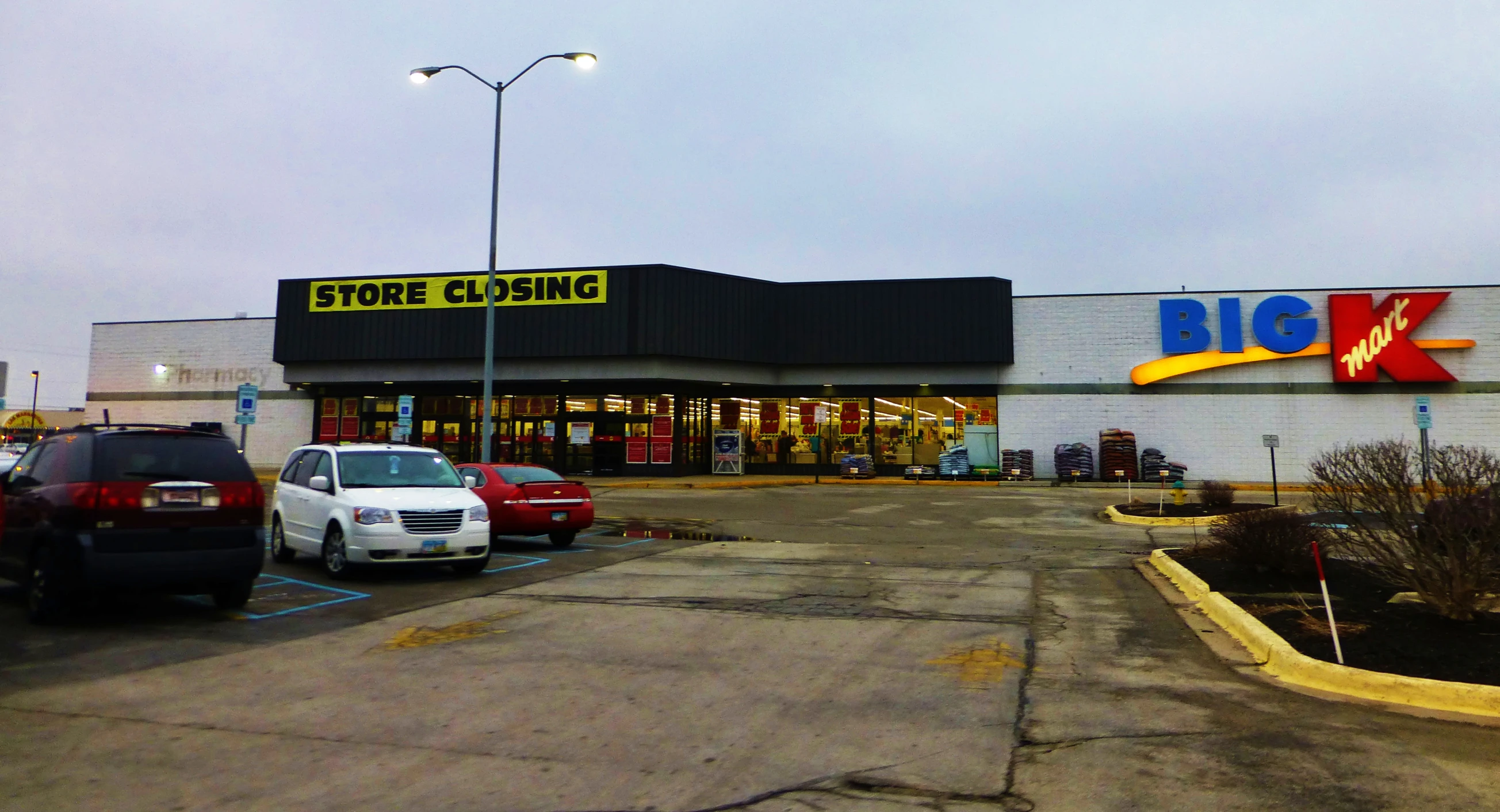 the store building is empty and the car is parked outside