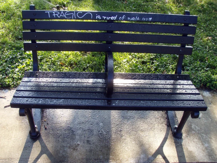 a park bench that has been written on it
