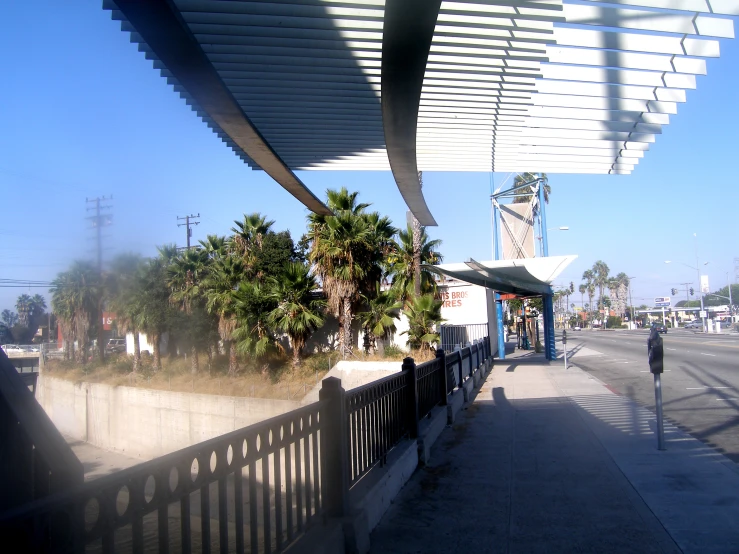 a bridge spanning an urban street on a sunny day