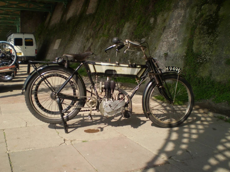 there is a bike parked on the sidewalk next to a mountain