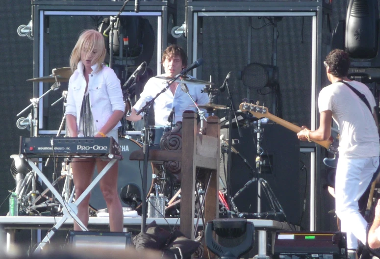 a man and woman singing on stage with an electric keyboard