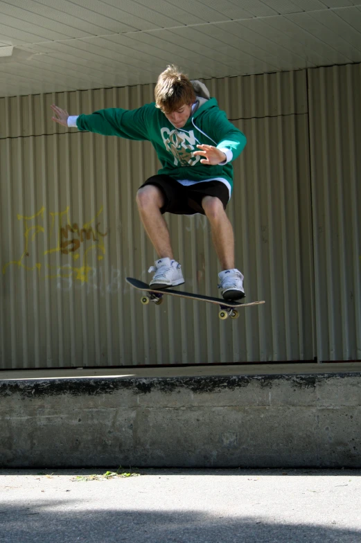 the skateboarder is jumping in the air with his board