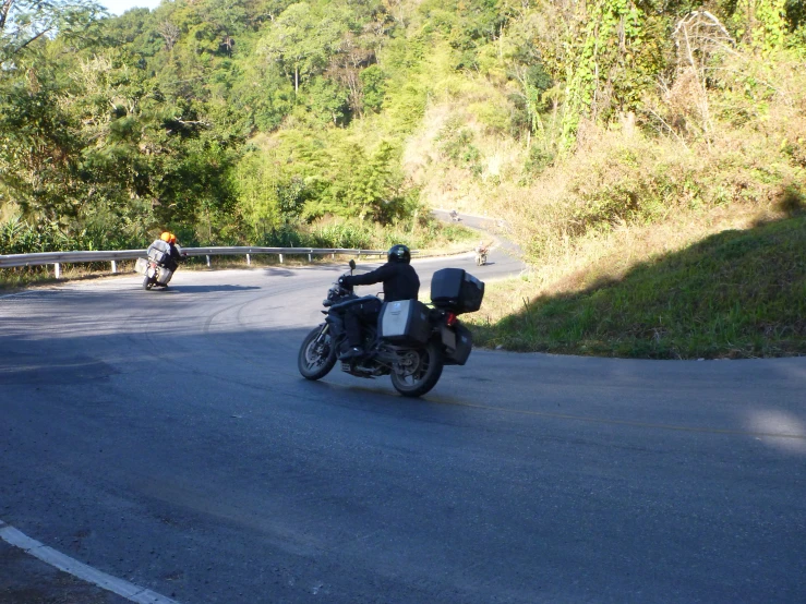 there are two motorcycles that are on the road