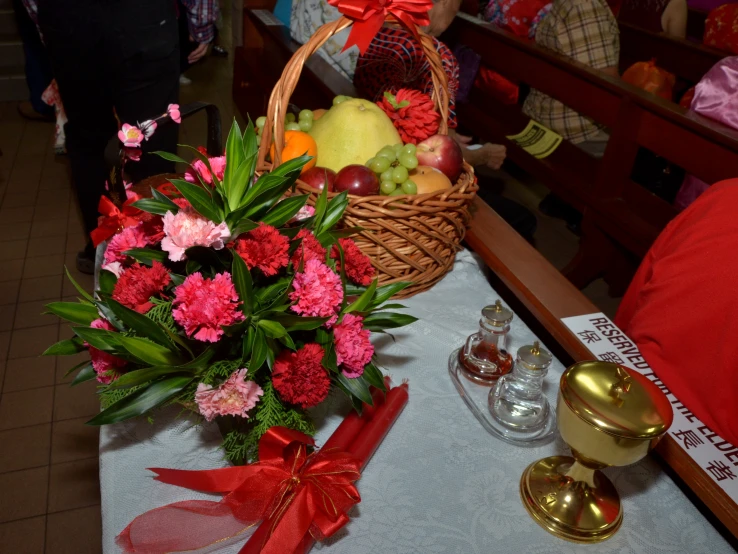 fruit and flowers in a basket, along with other accessories