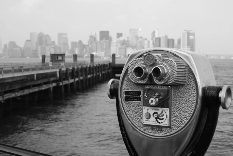 the view of an old time coin operated telescope near a large city