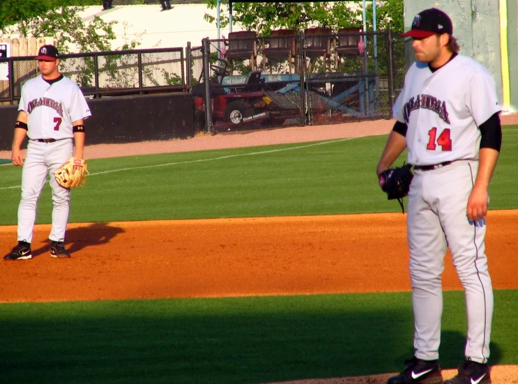 two baseball players on the field waiting for their turn