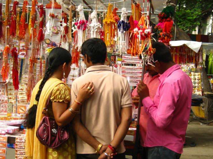 people talking in front of an assortment of colorful items