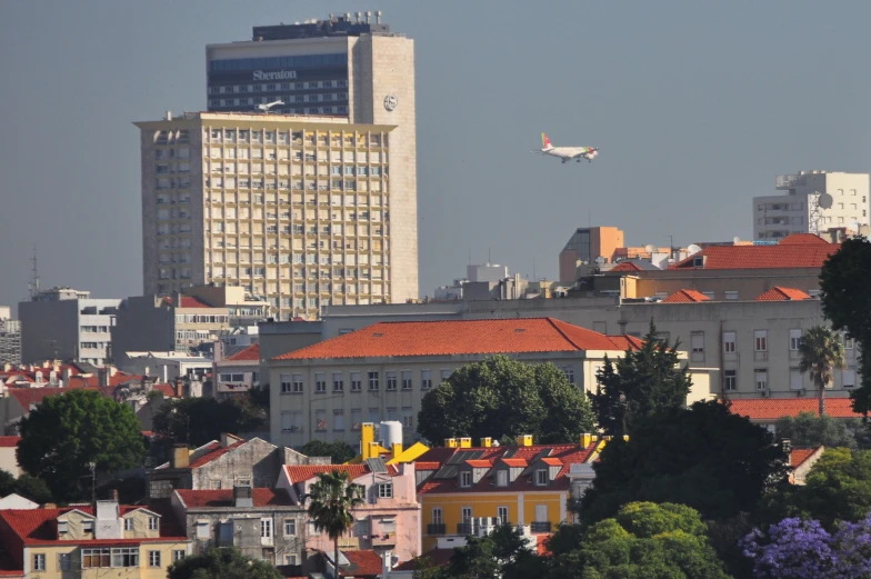 an airplane flying low to the ground near a city