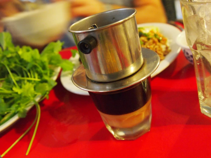 some food is on a red table, with glass and bowl