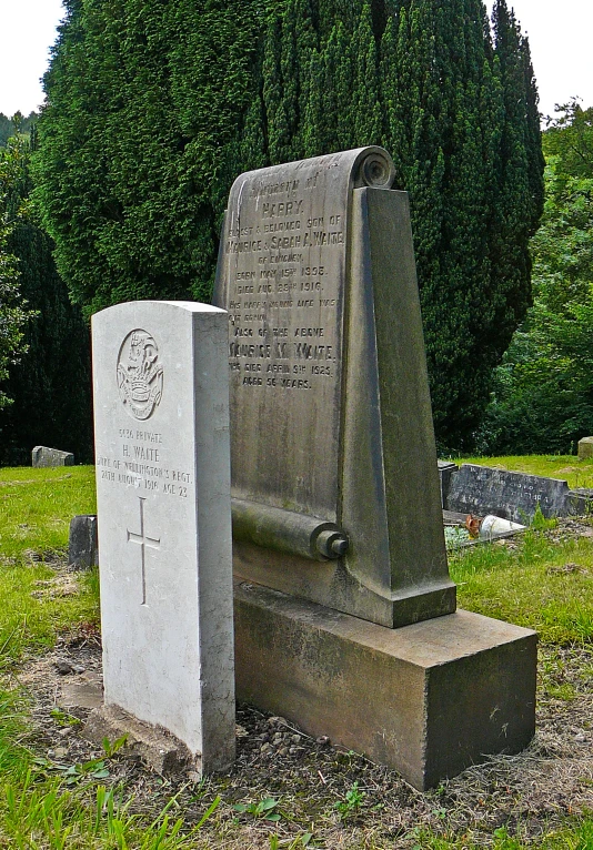 the monument in the field has a large cement obelisk