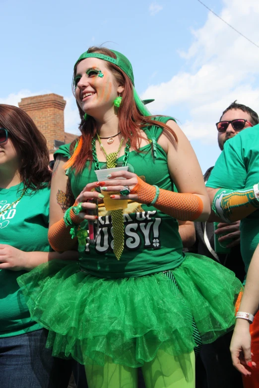 a woman in green dress is standing by other people