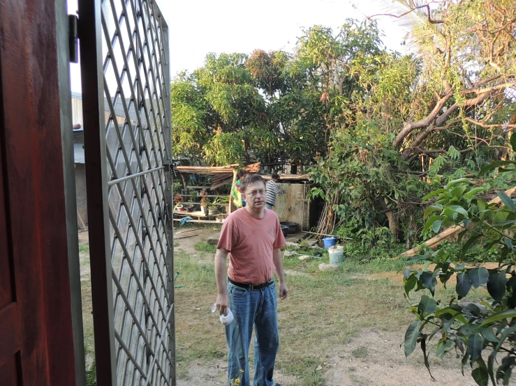 a man standing outside a house with no doors