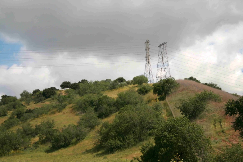 a hill that has telephone poles above it