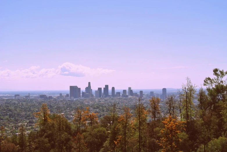 a city is shown from the top of a hill