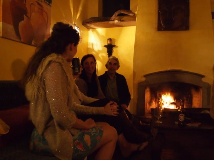 group of women gathered by fireplace at night