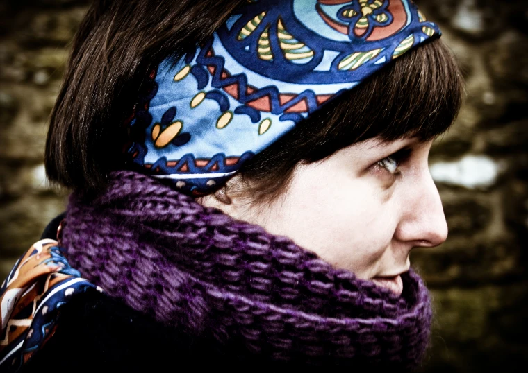 a woman with a scarf and a knitted headband