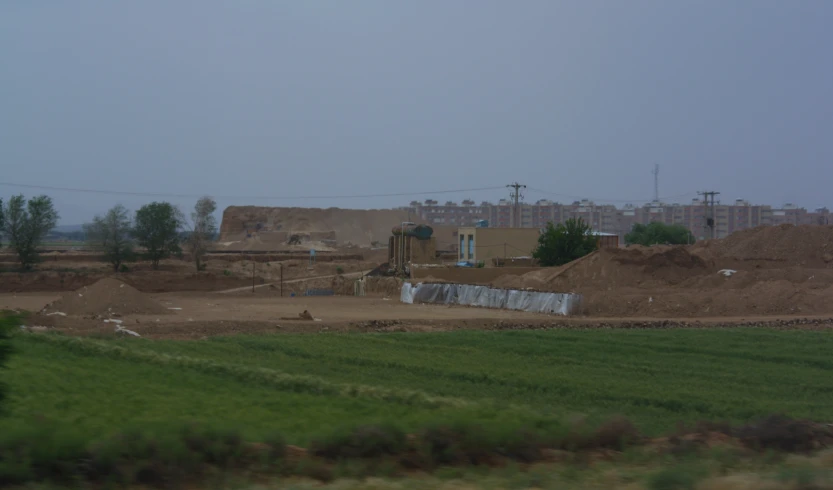 a large building is near many buildings under construction