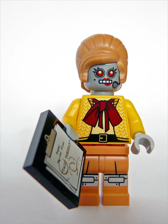 a lego man holding a card with an evil looking face