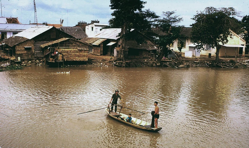 two men in a small boat on a river